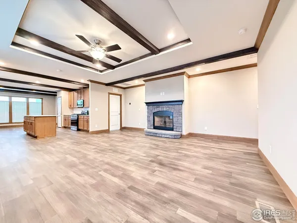 a view of empty room with wooden floor and fireplace