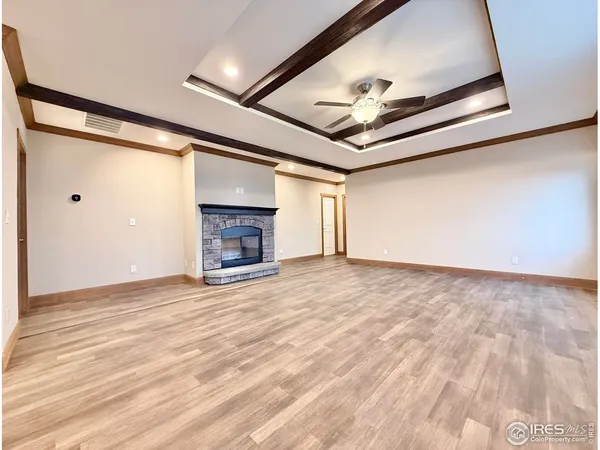 a view of an empty room with a fireplace and a window