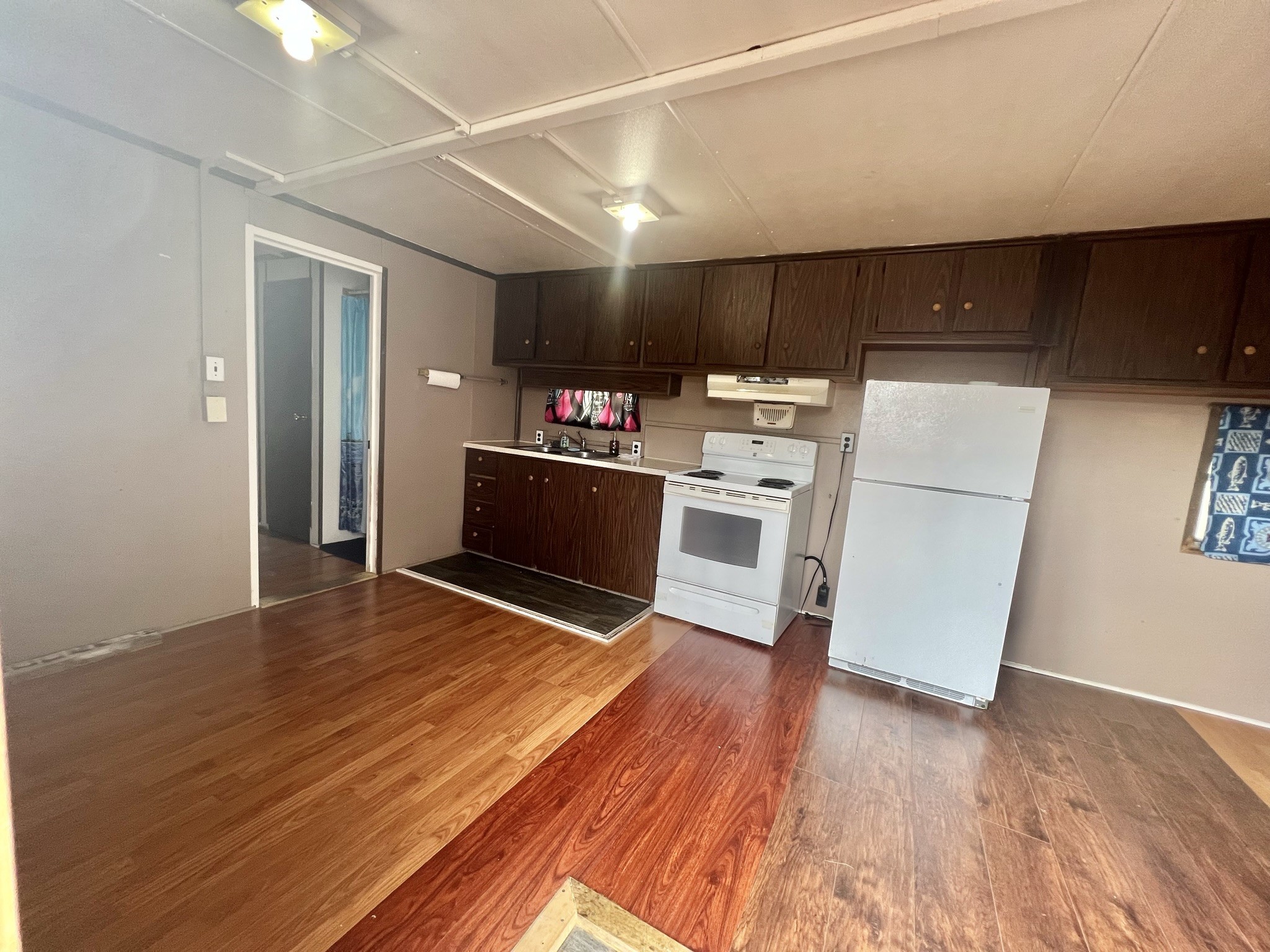 2749 Wagon Trail Road Pearland, TX 77584 - Photo 11 of 18 a kitchen with stainless steel appliances wooden floor and cabinets