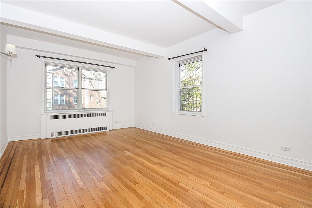 786 Palmer Road, Unit 2F Bronxville, NY 10708 - Photo 1 of 1 a view of an empty room with wooden floor and a window