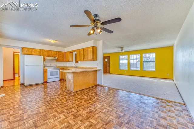 a view of a kitchen with a sink and a window
