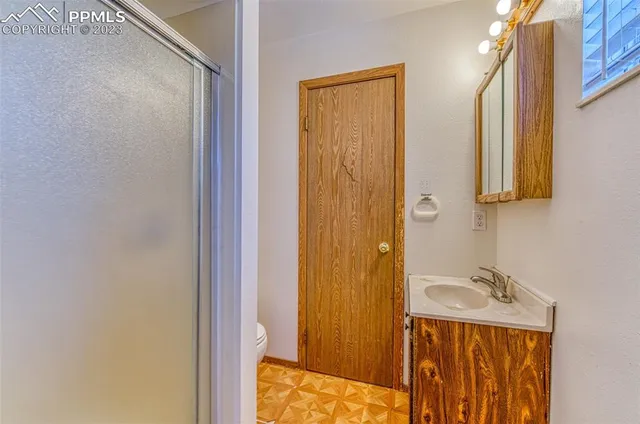 a bathroom with a sink a mirror and shower