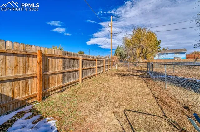 a view of yard with wooden fence