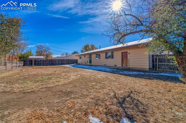 a view of house with backyard