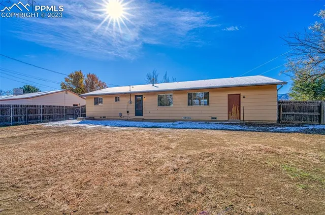 a view of house with backyard