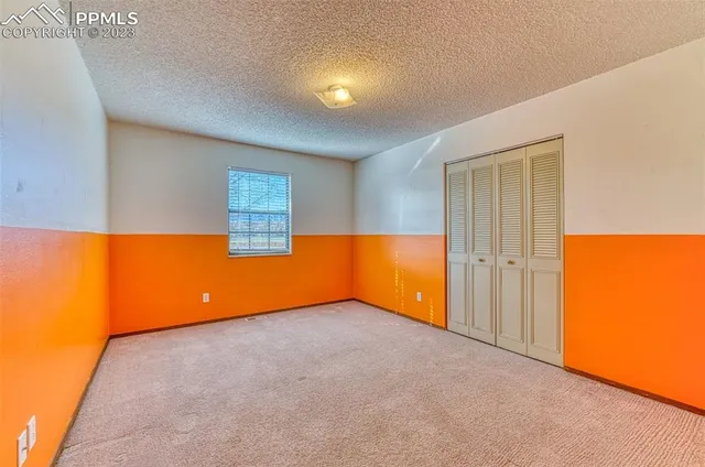 an empty room with a window and a projector