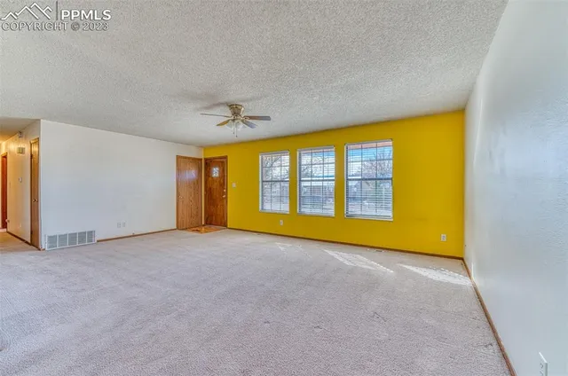 a view of an empty room with a window