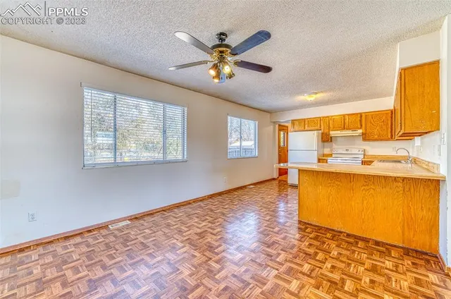 a view of a kitchen with a sink and a window