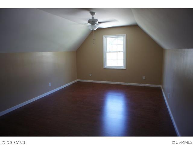 11605 Hillside Road Chester, VA 23831 - Photo 16 of 24 a view of an empty room with wooden floor and a window