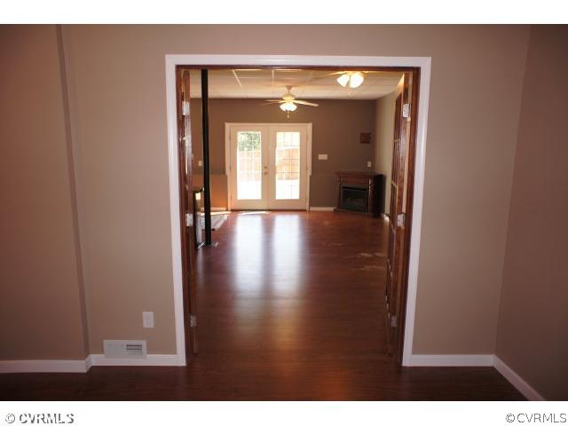 11605 Hillside Road Chester, VA 23831 - Photo 23 of 24 a view of a hallway with wooden floor and a living room