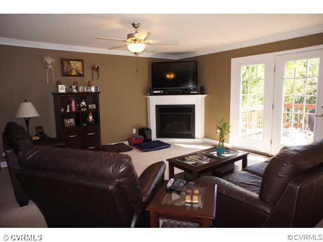 11605 Hillside Road Chester, VA 23831 - Photo 4 of 24 a living room with furniture a fireplace and a large window