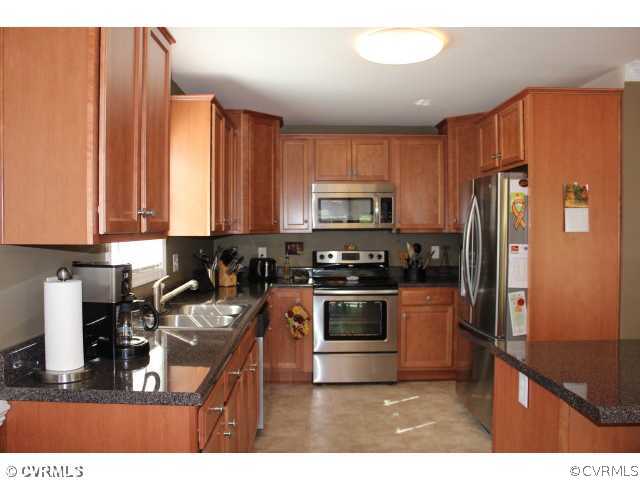 11605 Hillside Road Chester, VA 23831 - Photo 5 of 24 a kitchen with stainless steel appliances granite countertop a refrigerator a stove top oven a sink and dishwasher