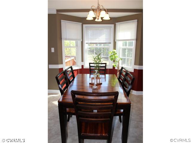 11605 Hillside Road Chester, VA 23831 - Photo 9 of 24 a living room with dining table and a large window