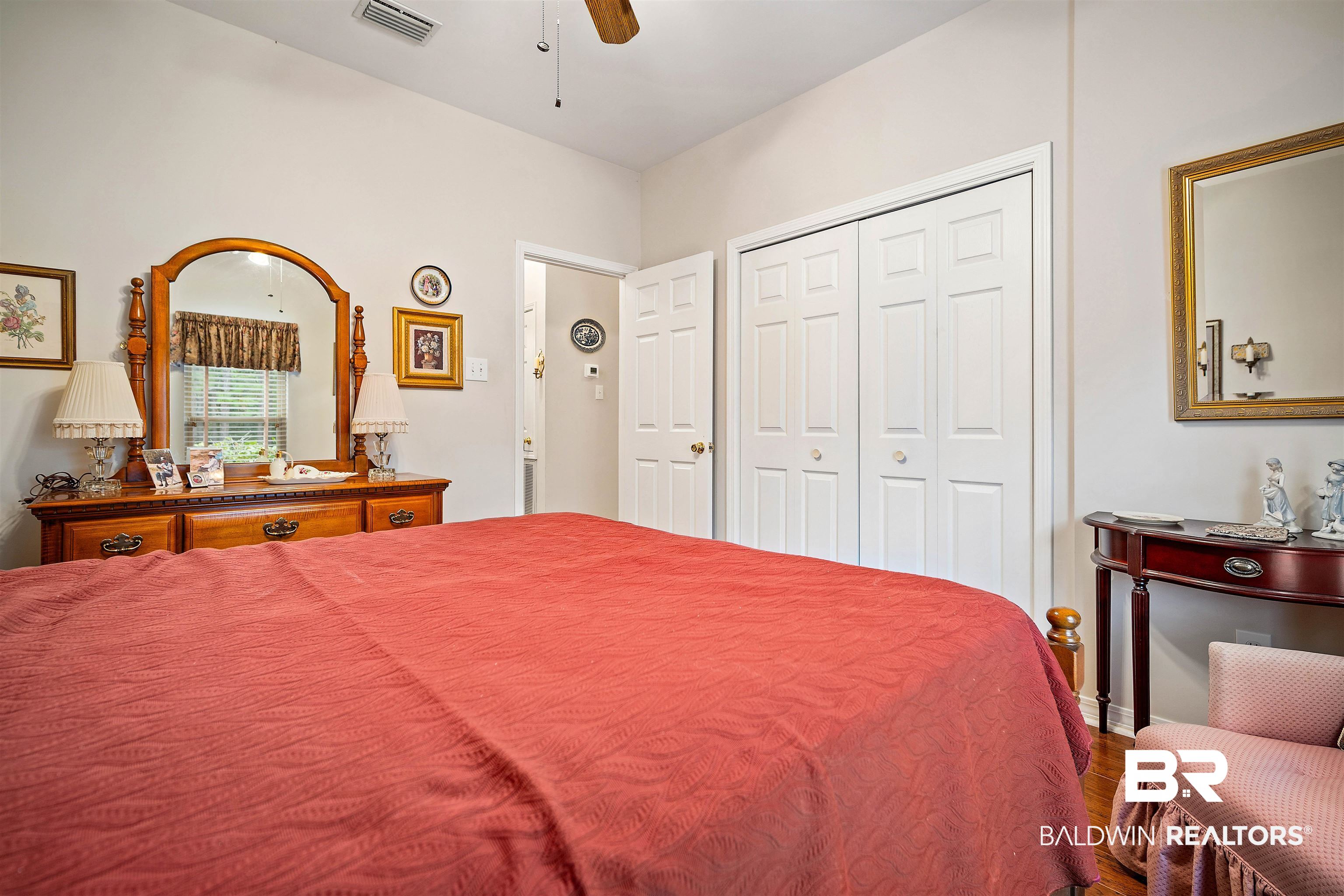 7419 Pake Road Saraland, AL 36571 - Photo 18 of 27 Bedroom with ceiling fan, wood-type flooring, and a closet