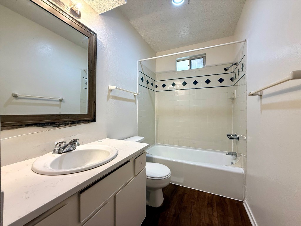 1509 Cinnamon Path, Unit B Austin, TX 78704 - Photo 15 of 19 a bathroom with a sink a toilet a mirror and shower
