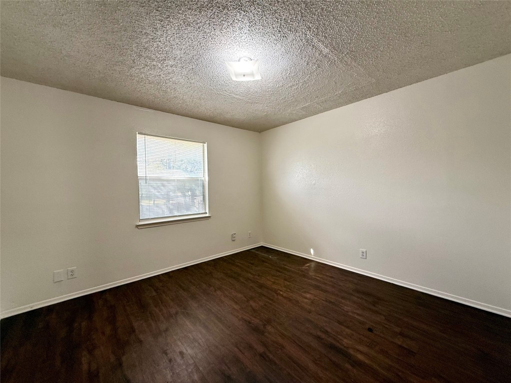 1509 Cinnamon Path, Unit B Austin, TX 78704 - Photo 17 of 19 an empty room with wooden floor and windows
