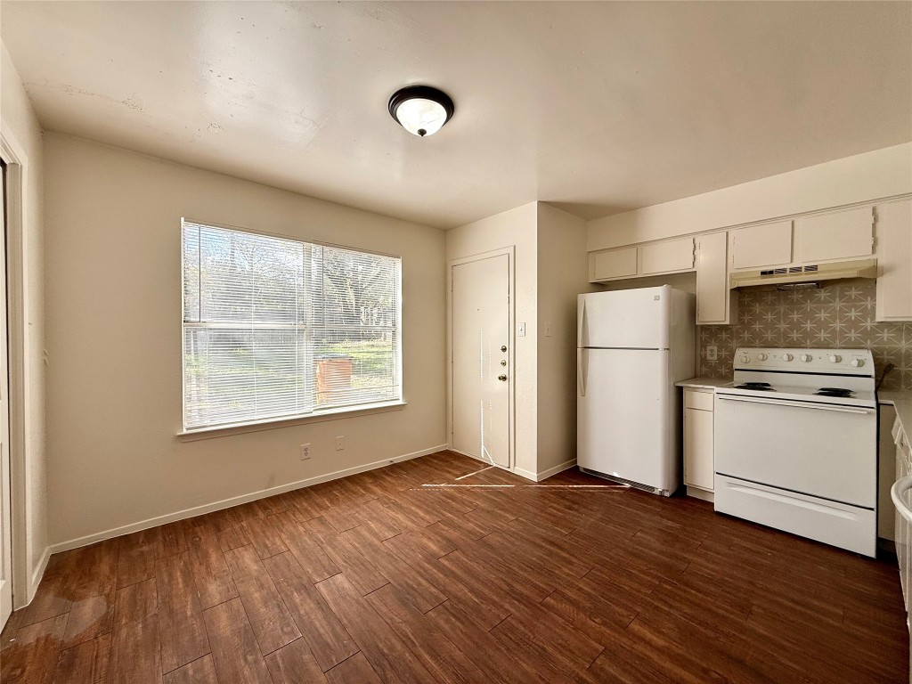 1509 Cinnamon Path, Unit B Austin, TX 78704 - Photo 5 of 19 a kitchen with a refrigerator and white cabinets
