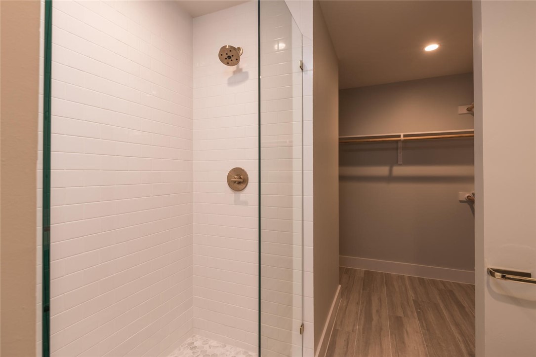 505 West 7th Street, Unit 103 Austin, TX 78701 - Photo 11 of 21 a bathroom with a shower and a door