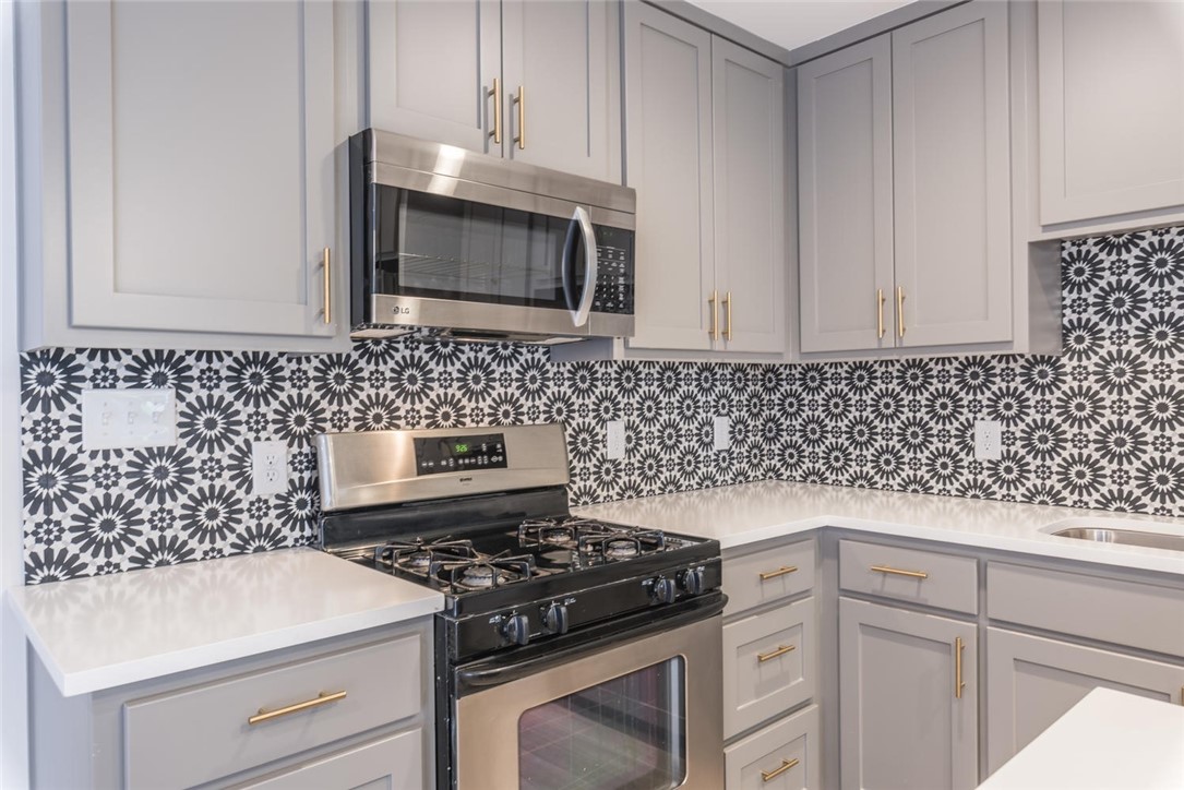 505 West 7th Street, Unit 103 Austin, TX 78701 - Photo 5 of 21 a kitchen with granite countertop cabinets and a stove top oven