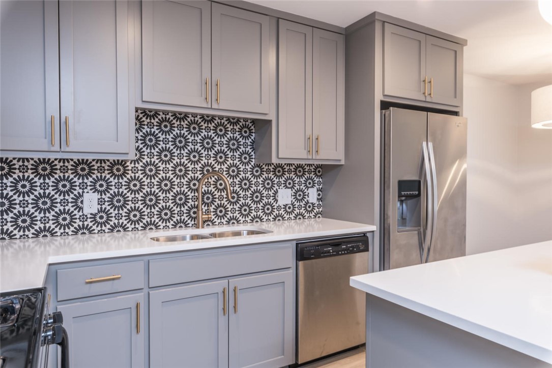 505 West 7th Street, Unit 103 Austin, TX 78701 - Photo 6 of 21 a kitchen with cabinets and stainless steel appliances