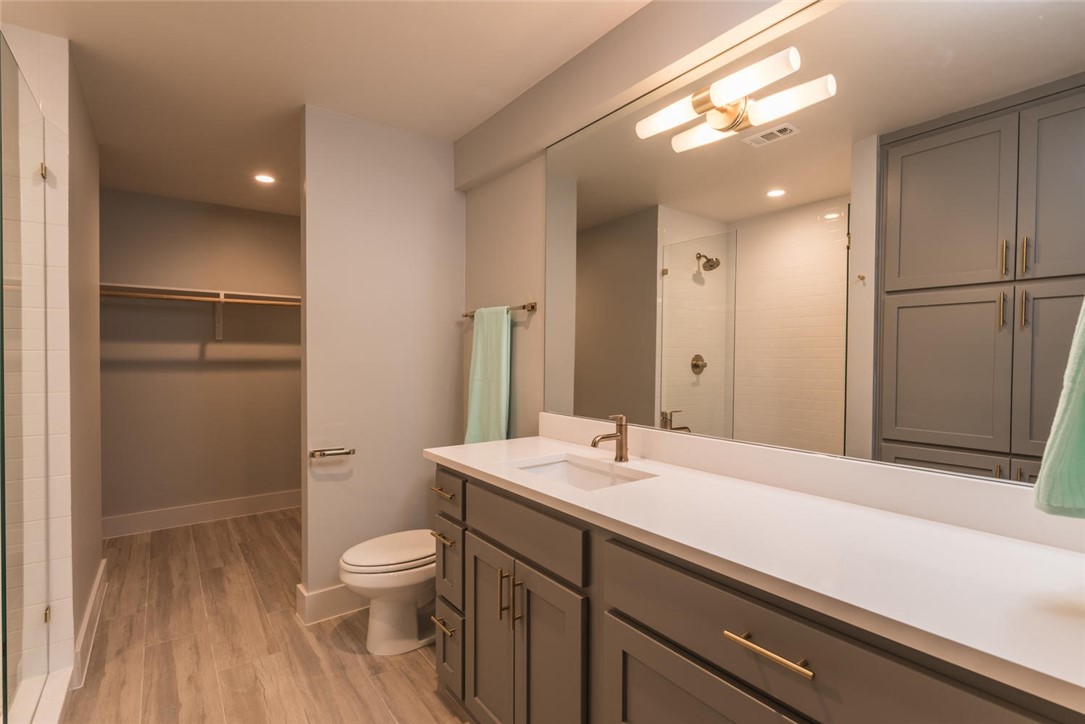 505 West 7th Street, Unit 103 Austin, TX 78701 - Photo 10 of 21 a bathroom with a sink a toilet and shower
