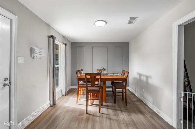 a view of a dining room with furniture and wooden floor