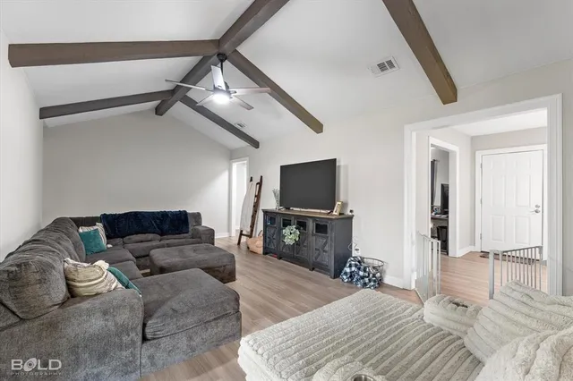 a bedroom with furniture and a flat screen tv