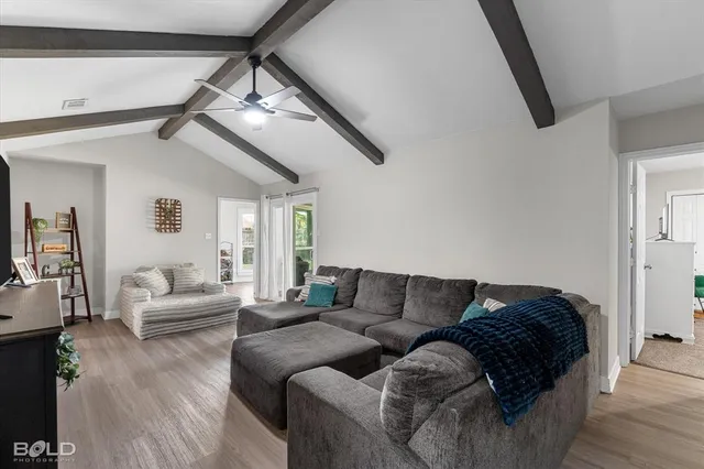 a living room with furniture and wooden floor