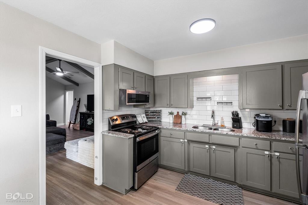 2517 Conrad Street Bossier City, LA 71111 - Photo 19 of 39 a kitchen with stainless steel appliances a sink a stove top oven a counter space and cabinets