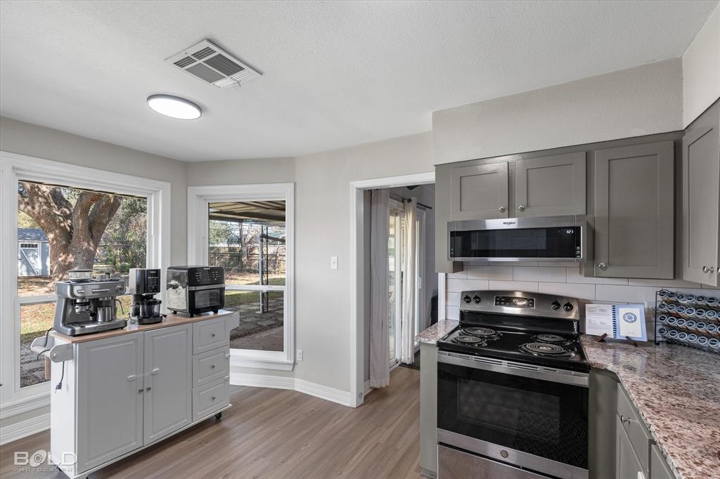 2517 Conrad Street Bossier City, LA 71111 - Photo 20 of 39 a kitchen with stainless steel appliances a stove a sink a refrigerator and cabinets