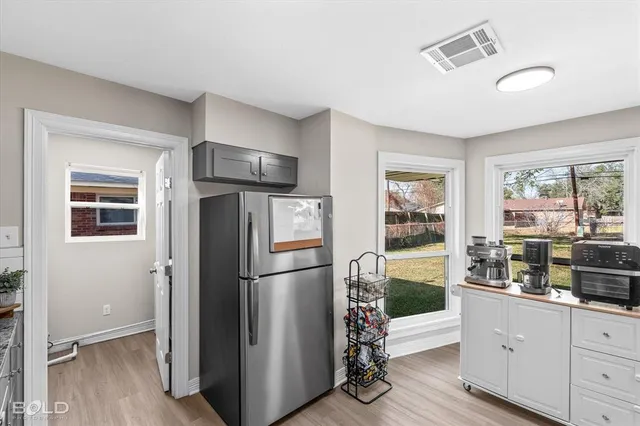 a kitchen with stainless steel appliances granite countertop a refrigerator and a stove top oven
