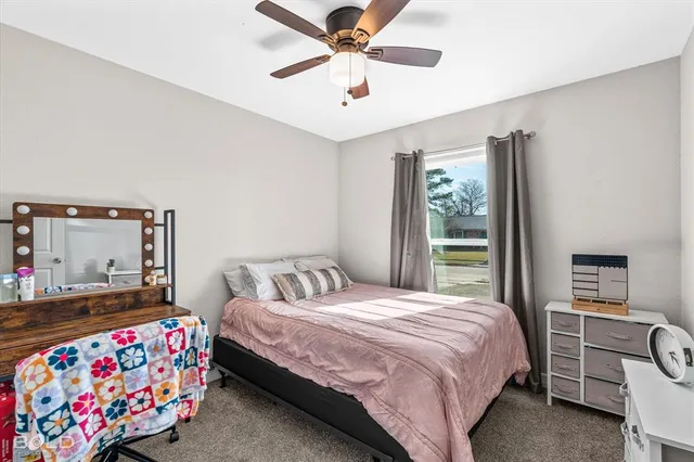 a bedroom with a bed and a window