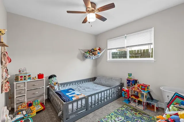 a bedroom with furniture and a baby crib