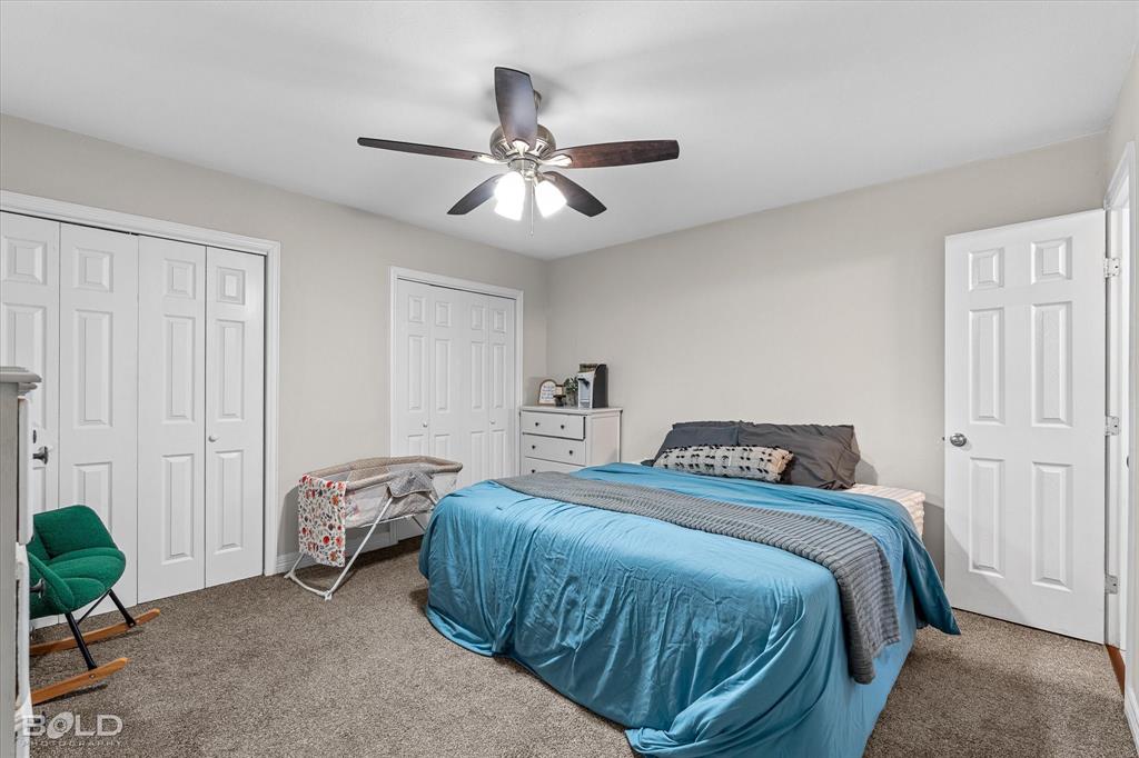 2517 Conrad Street Bossier City, LA 71111 - Photo 31 of 39 a bedroom with a bed and a chandelier