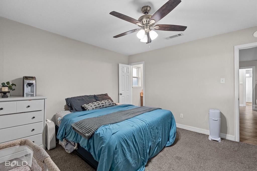 2517 Conrad Street Bossier City, LA 71111 - Photo 32 of 39 a bedroom with a large bed and a chandelier