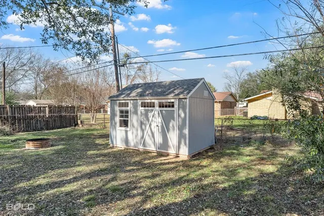 a view of a barn in the yard