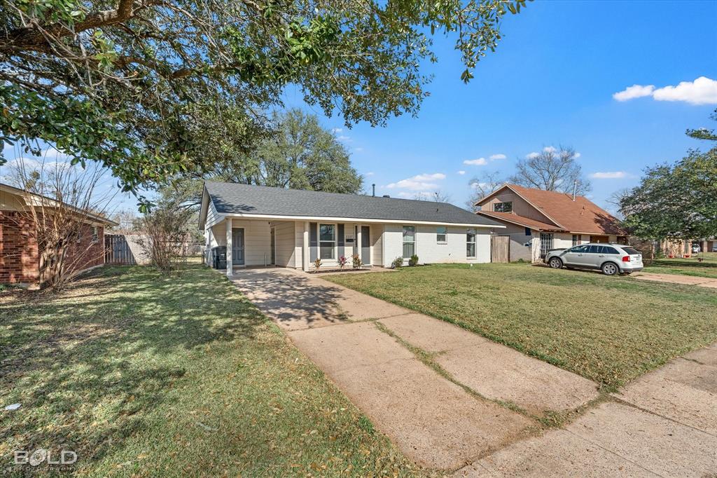 2517 Conrad Street Bossier City, LA 71111 - Photo 7 of 39 a front view of a house with a garden