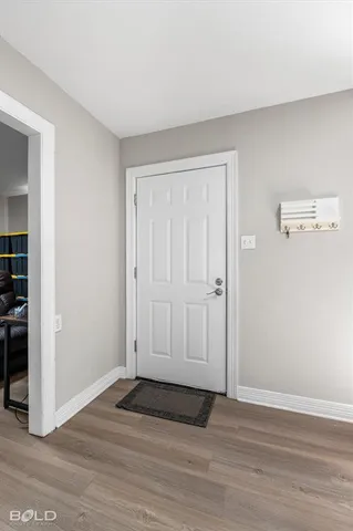 a view of an empty room and wooden floor