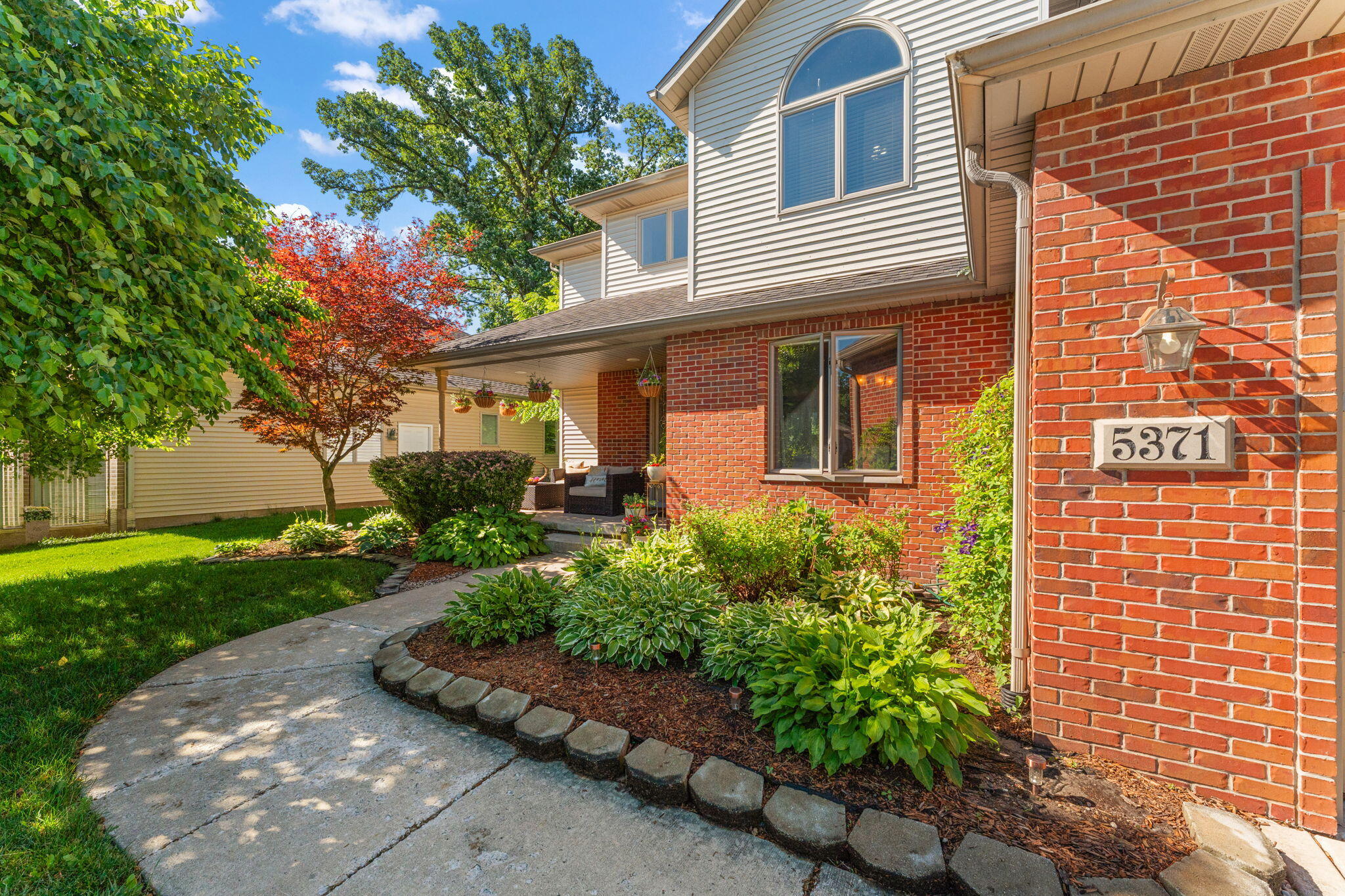 5371 72nd Avenue Schererville, IN 46375 - Photo 3 of 28 a front view of a house with garden