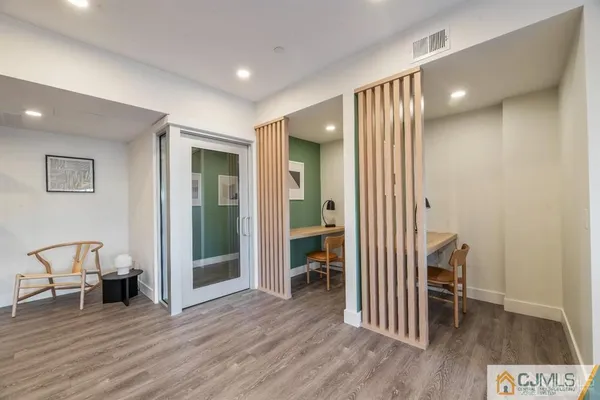 a view of a room with wooden floor and window
