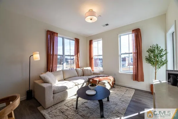 a bedroom with furniture and wooden floor