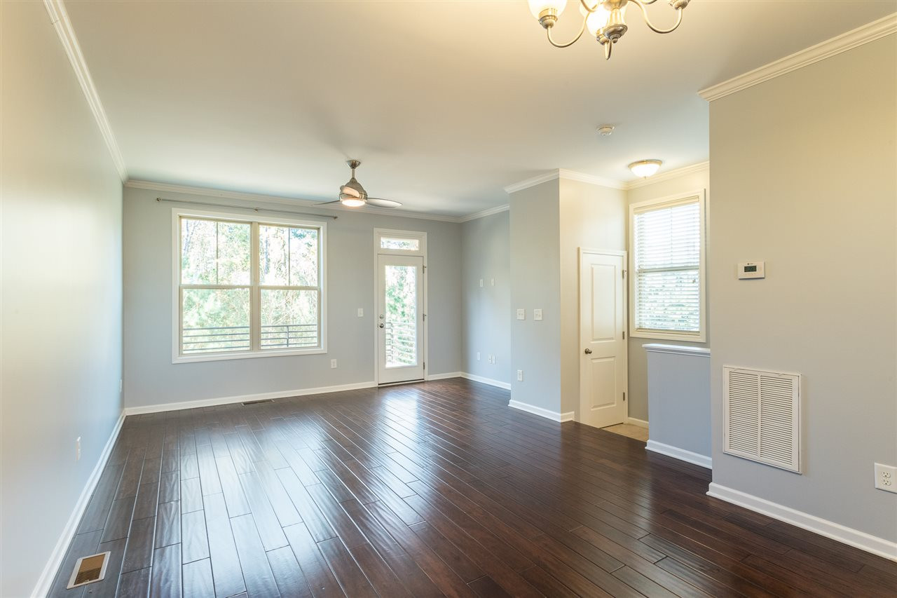 Sunlit and spacious family room with beautiful hardwood floors Family Room