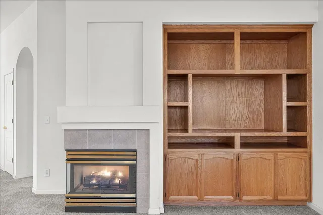a kitchen with white cabinets and a fireplace