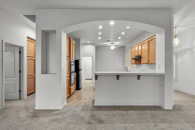 a view of kitchen and kitchen with stainless steel appliances wooden floor