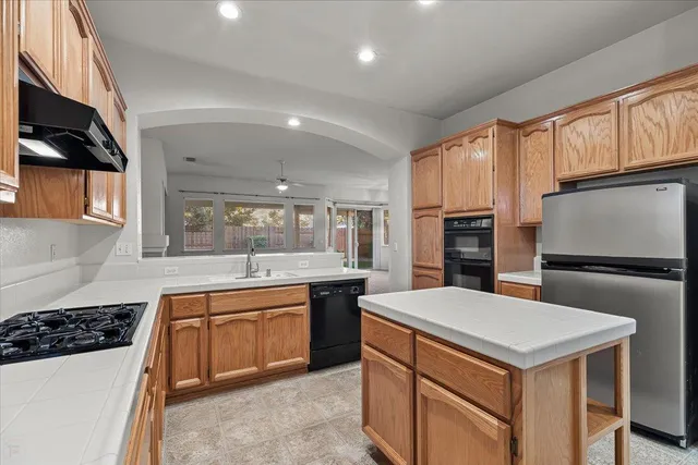 a kitchen with a sink a stove and refrigerator