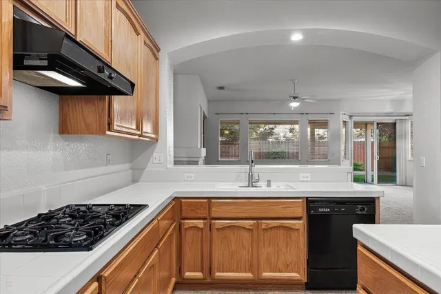 a kitchen with a sink stove and cabinets
