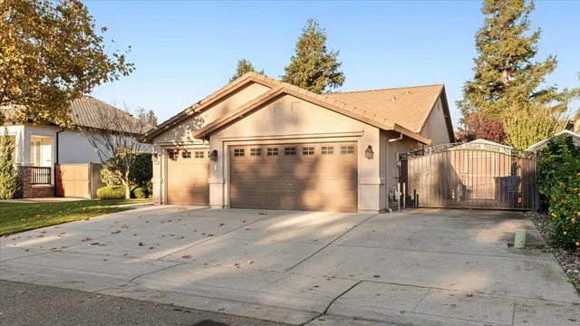 a view of a white house with a big yard and large trees