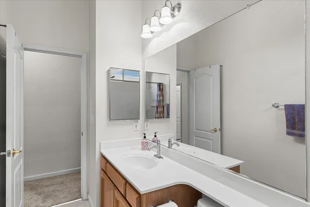 a bathroom with a sink a mirror and a shower