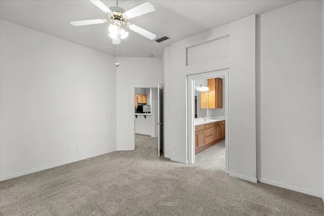 an empty room with fan and entrance