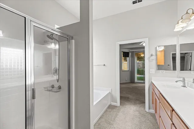 a bathroom with a tub sink and mirror